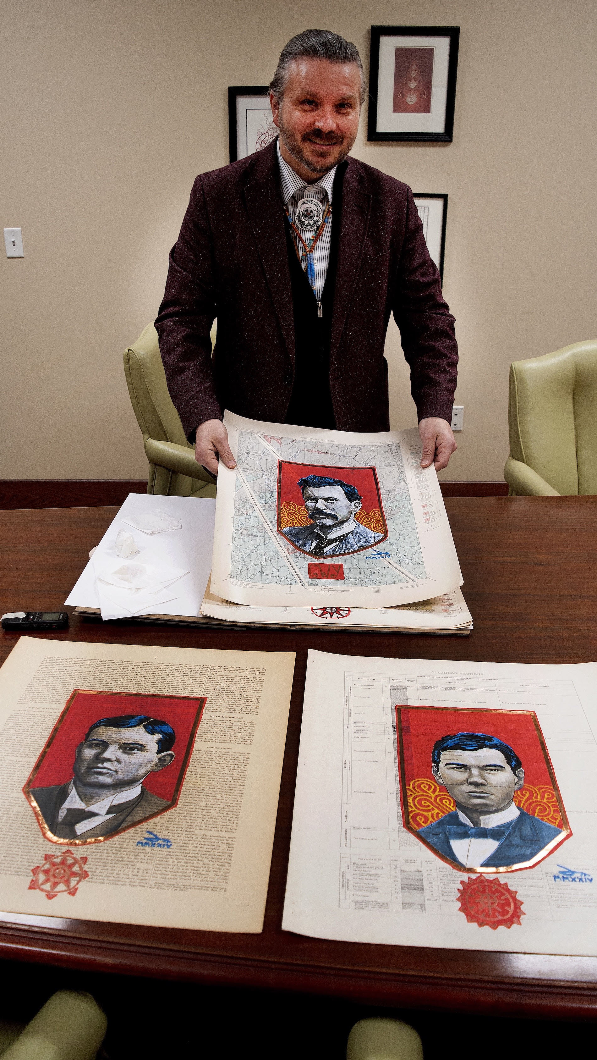 Acclaimed Chickasaw artist Dustin Mater is shown with a few of his ledger paper portraits commissioned by Vanderbilt University to honor 12 Chickasaw and Cherokee students who fought for admission to the university in the 1800s. (Photo/Chickasaw Nation Media)
