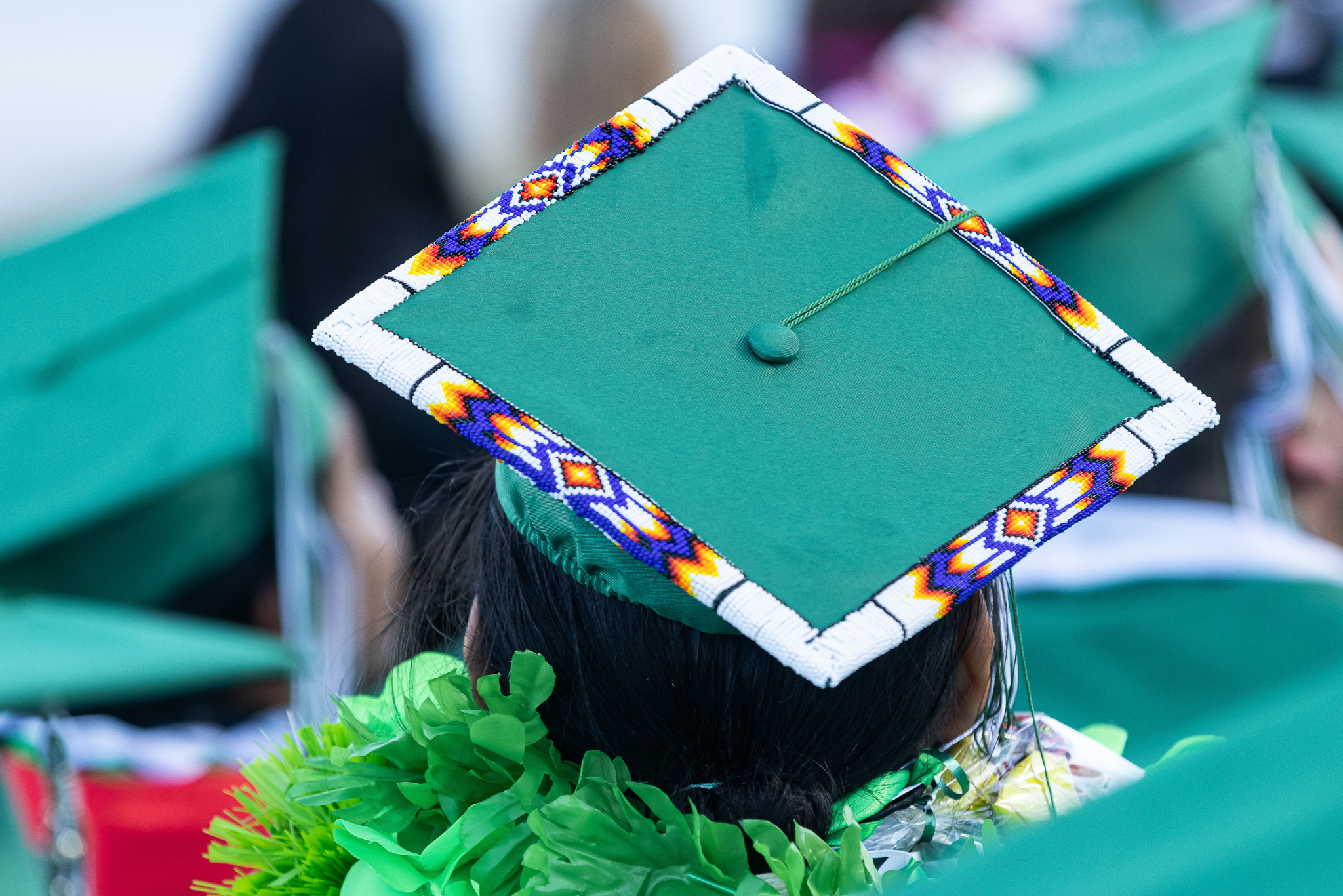 Farmington High School graduate Darrison Abeyta wears a beaded cap at the commencement exercises on Tuesday, May 20, 2025 at Hutchison Stadium. (Photo/Curtis Ray Benally / High Country News)