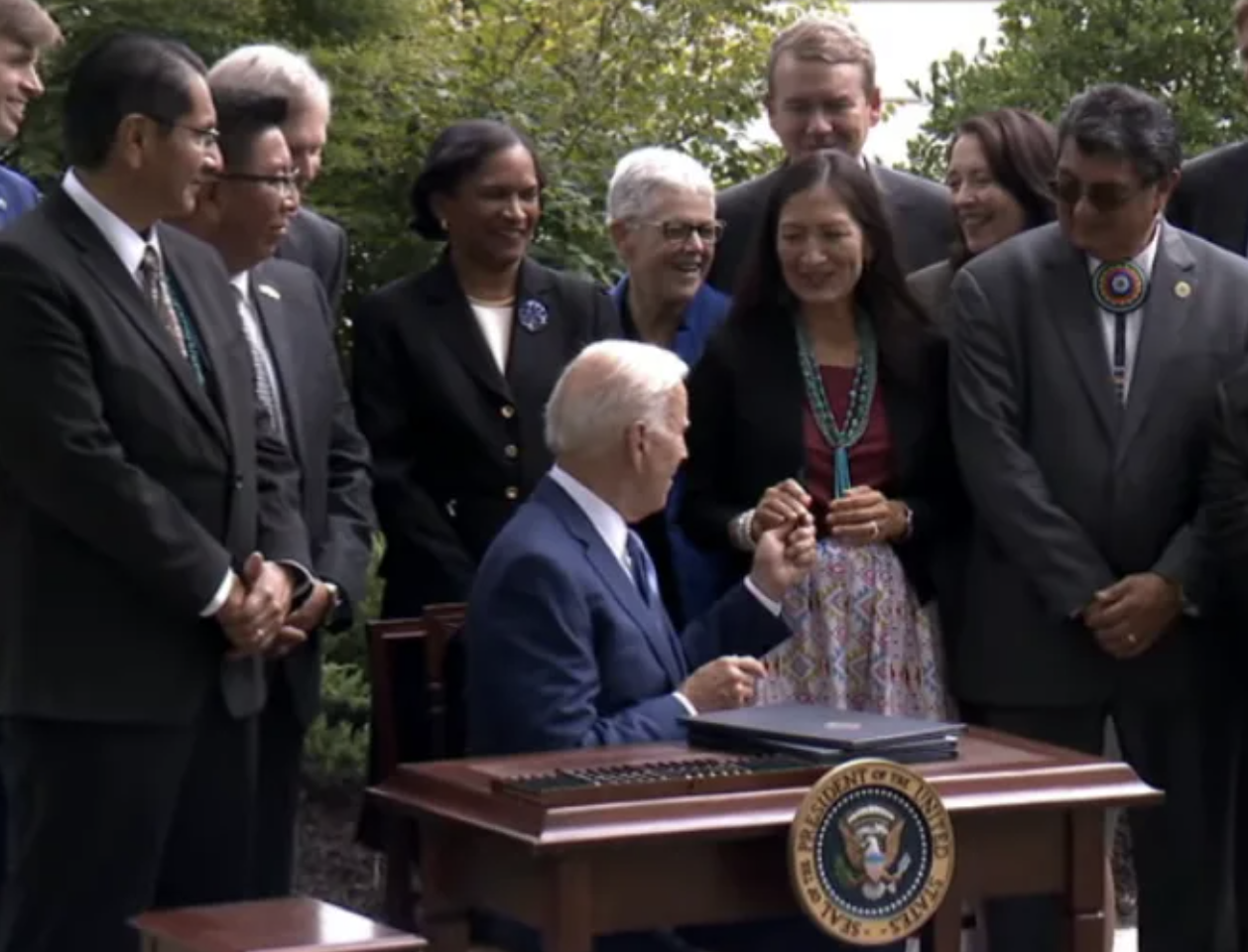President Biden presents pen he used to sign Bears Ears Proclamation to Interior Sec. Deb Haaland. (Photo/The White House Live)