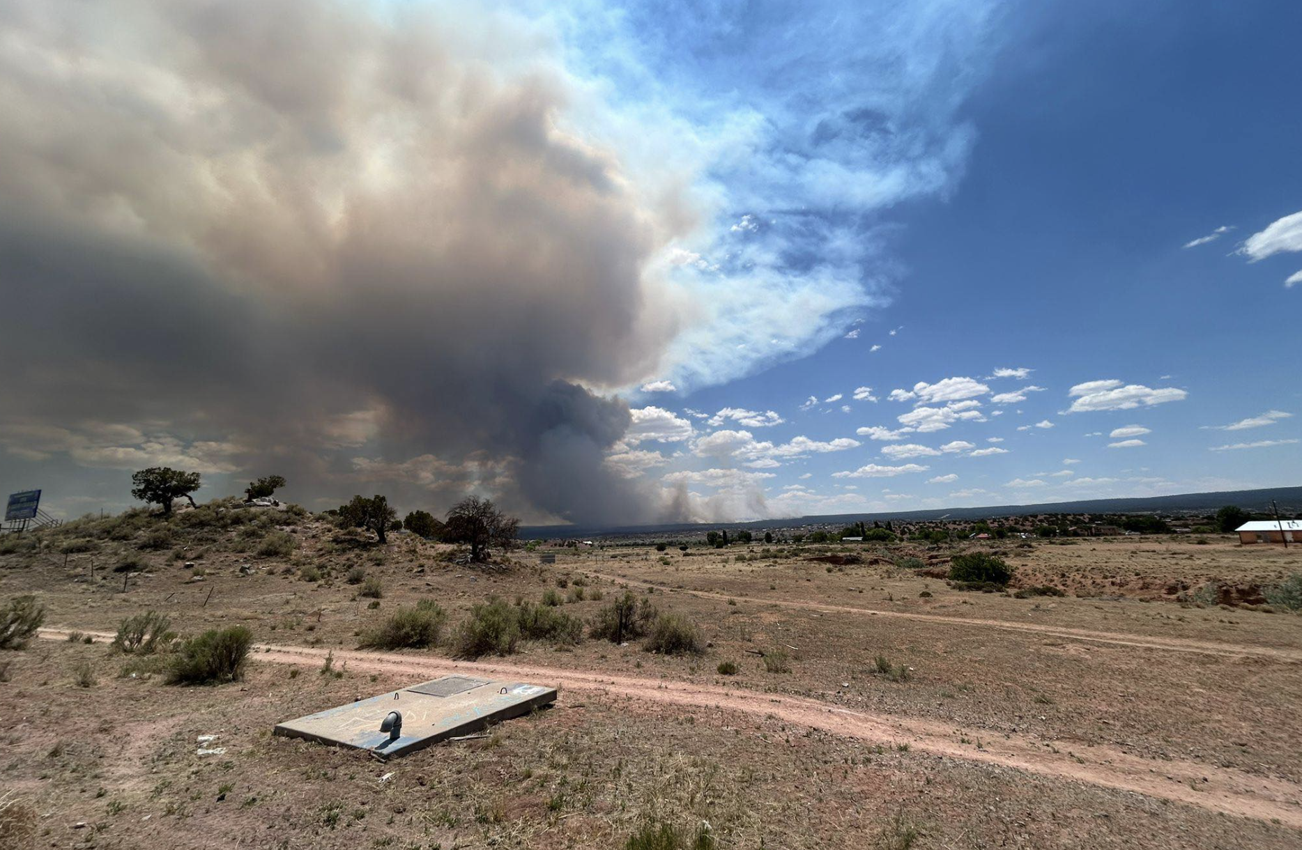 Smoke rises from the Oak Springs Fire that ignited Saturday on the Navajo Nation a few miles from the New Mexico border. It’s already the second-biggest fire on the Navajo Nation in more than a decade, according to a Source review. (Photo courtesy Navajo Nation President Buu Nygren’s Facebook page)