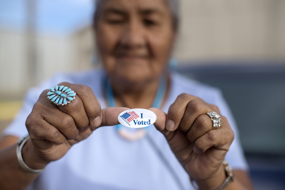 woman with “I voted” sticker