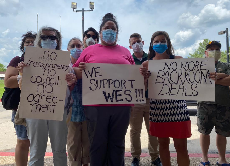 Protesters holding signs