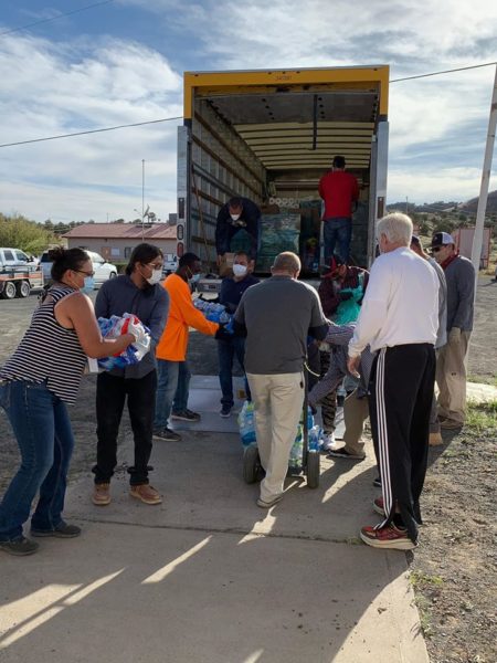 Volunteer help distribute food and water on Navajo Nation.